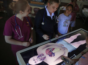  students work on a surgery simulation