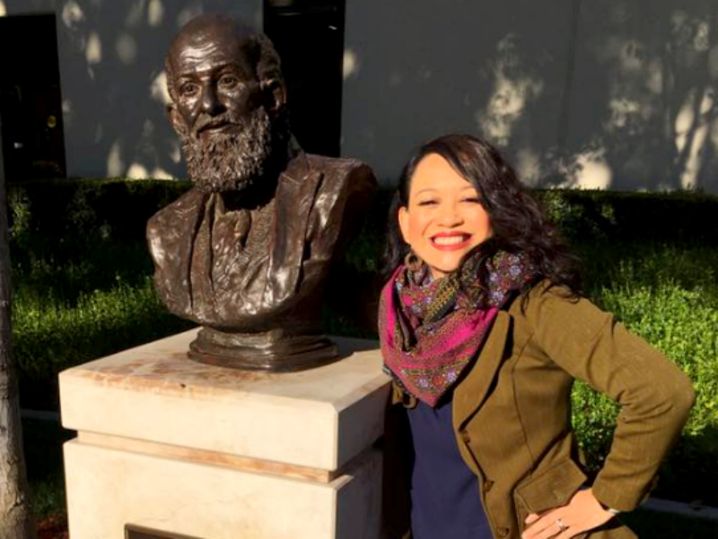 Dr. Tingtangco-Cubales with a bust of Paulo Freire