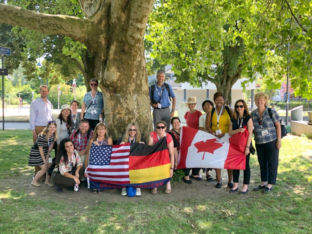 Educators outside with U.S., German and Canadian flags