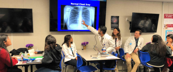 Medical students point to an X-ray image