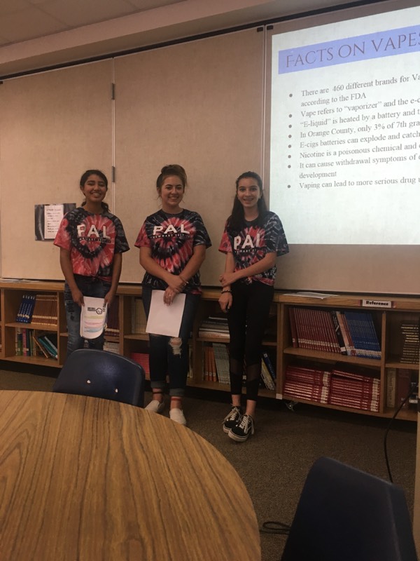 Three students giving a presentation