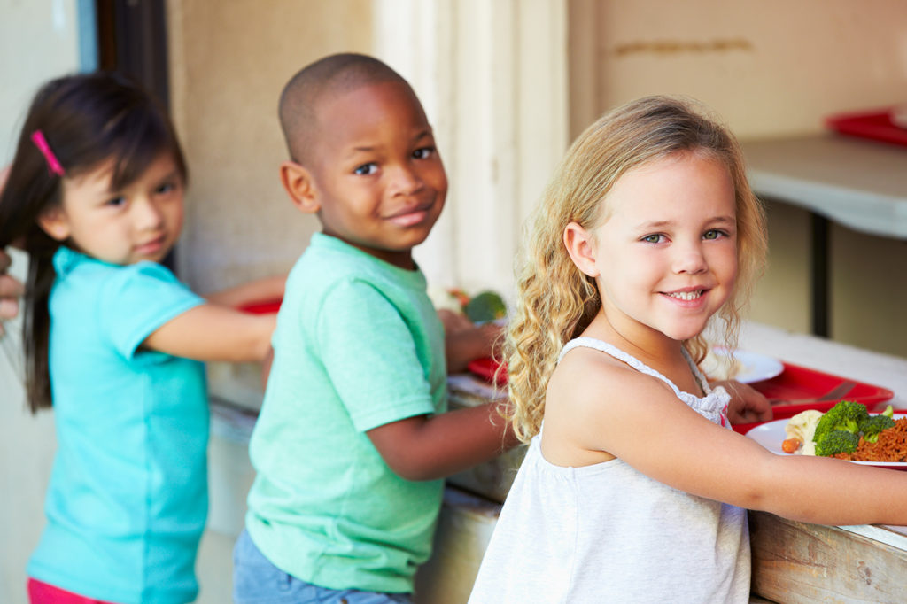 Elementary Pupils Collecting Healthy Lunch In Cafeteria