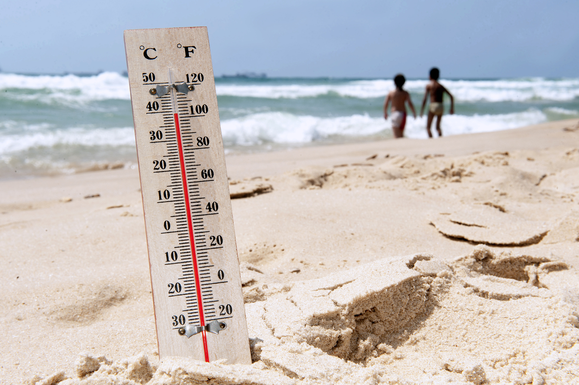 An image of a thermometer on the beach