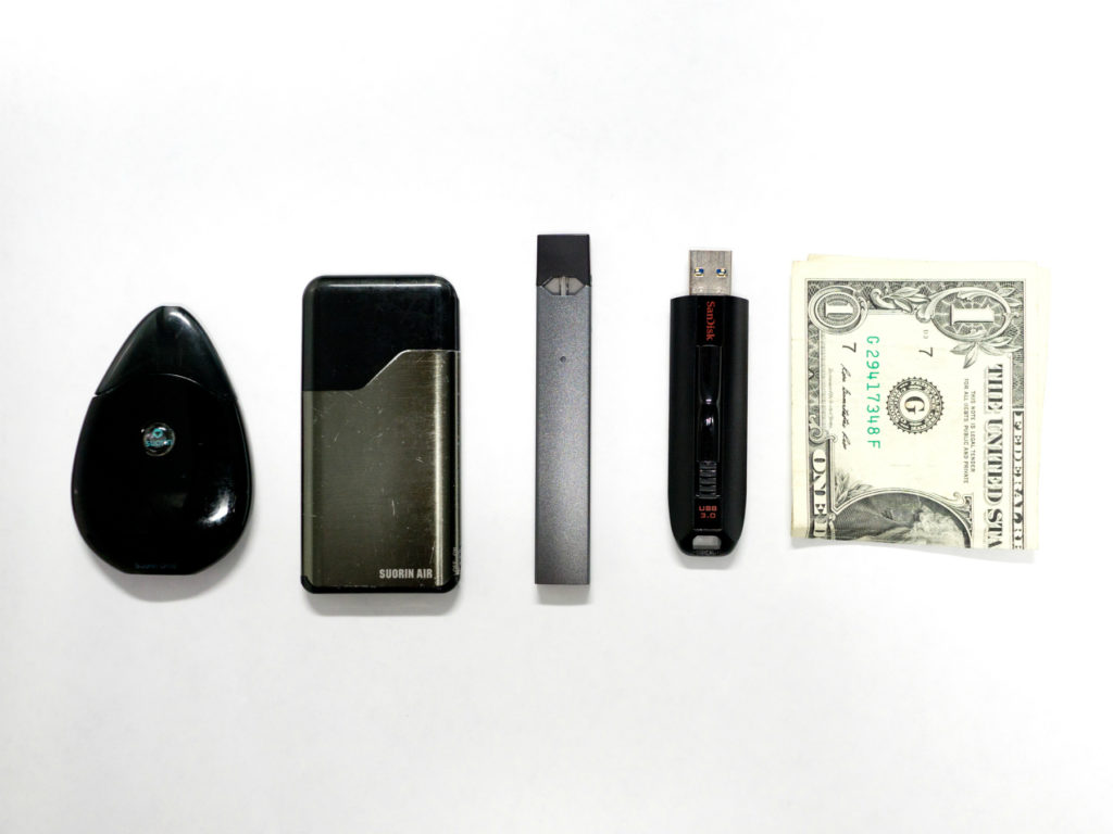 Vape devices and a folded dollar bill