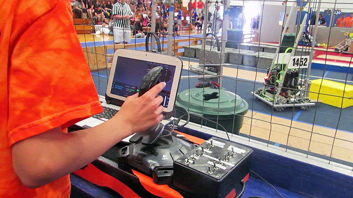 An image of a student controlling a robotics project