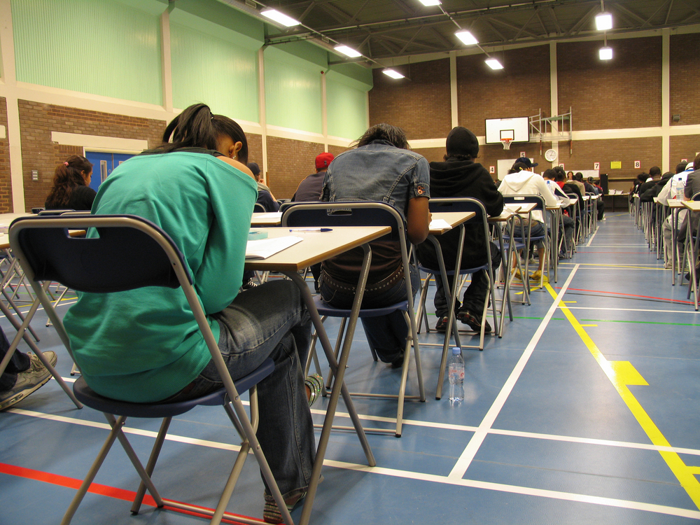 students taking a test in a gym