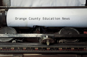 An image of paper in a typewriter with the words "Orange County Education News"