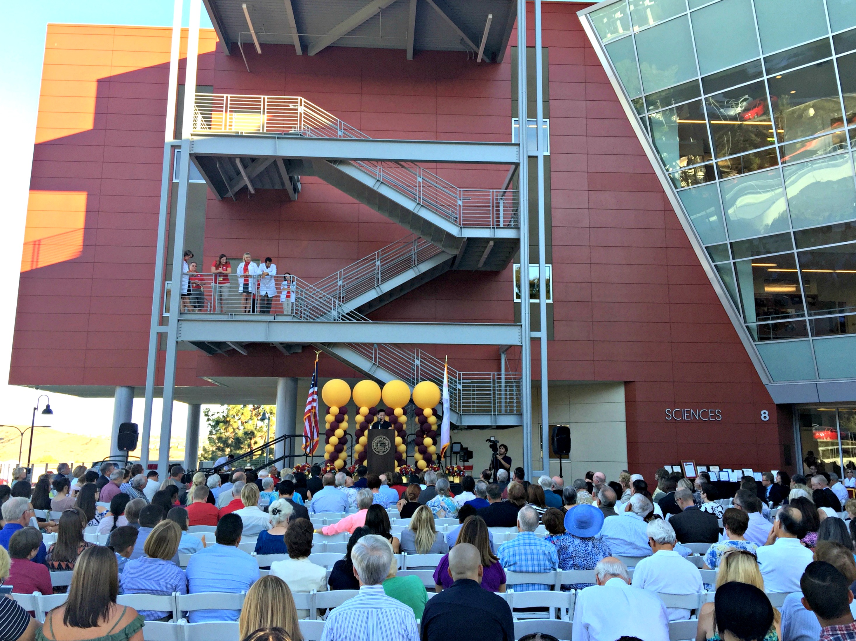 An image of a speaker outside the new Science Building at Saddleback College