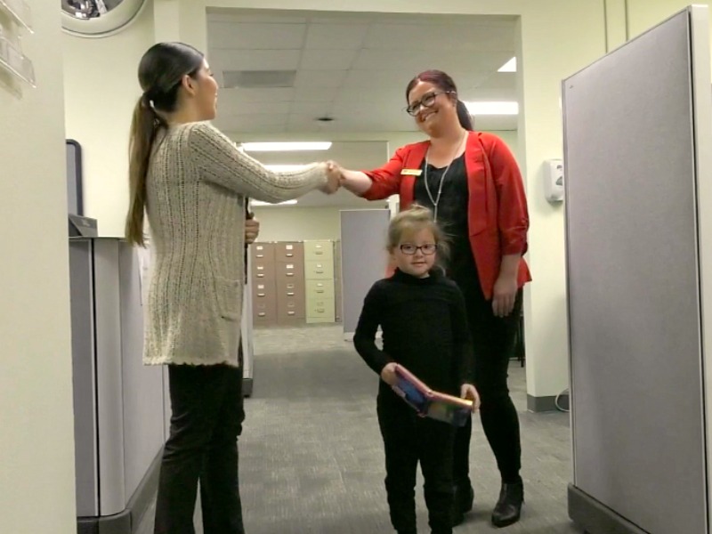 A mother and daughter are greeted at OCDE's Child Care Services program