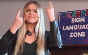 Deaf and hard of hearing student uses sign language to repeat music lyrics