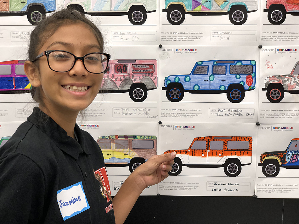 Student Jazmine Alvarado points to her tiger design for an SUV