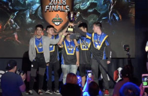 students hold up trophy after winning tournament