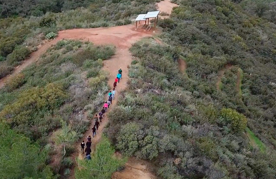 Students hike up a hill