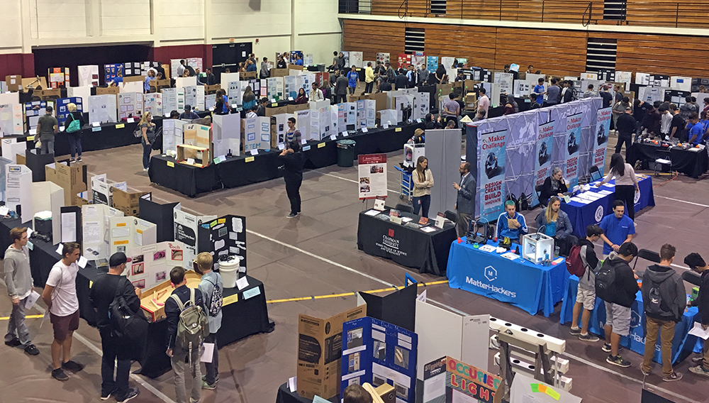 students exhibit projects inside a gymnasium
