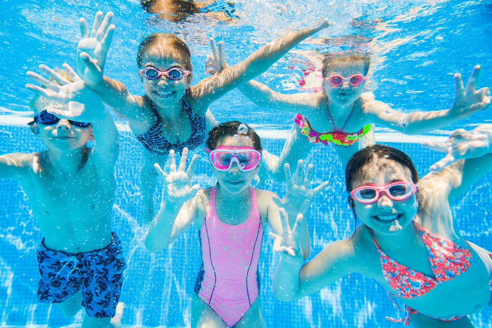 a group of children under water in a swimming pool