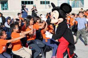 Mickey Mouse greets excited students