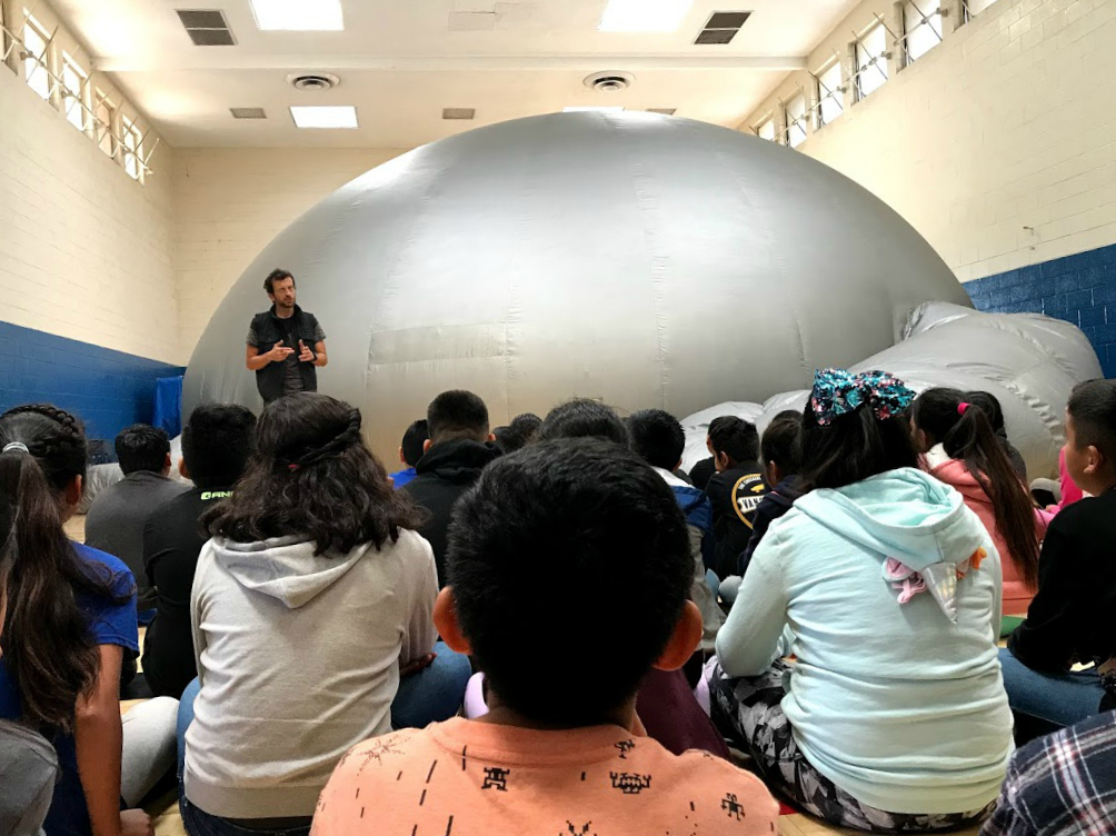 Students sitting in front of the inflatable SkyDome Planetarium