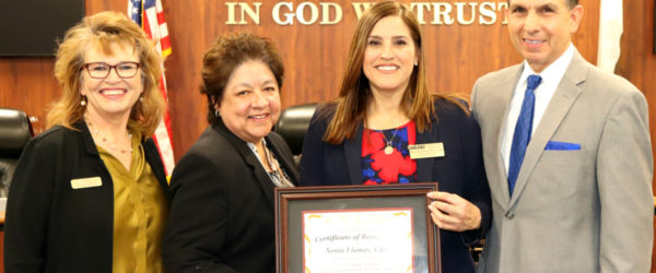 Dr. Sonia Llamas, assistant superintendent in the Santa Ana Unified School District, holds her award