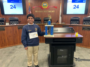 Eighth-grader Nicholas D’Sa holds trophy