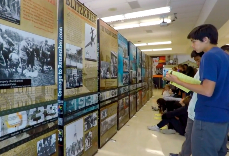Students inspect the "Courage to Remember" Holocaust exhibit