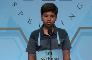 student on stage during spelling bee