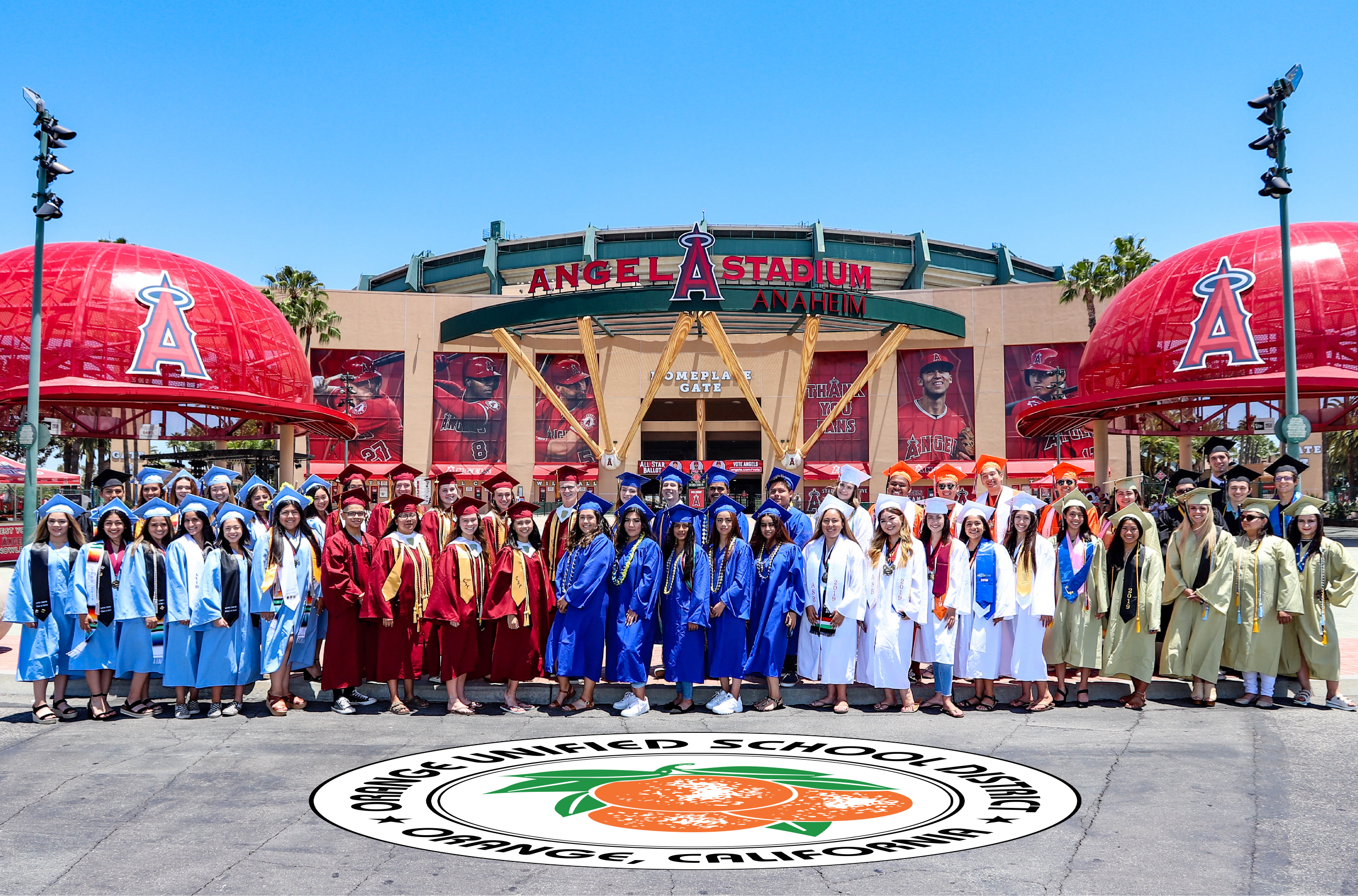 high school grads pose in front of angel stadium