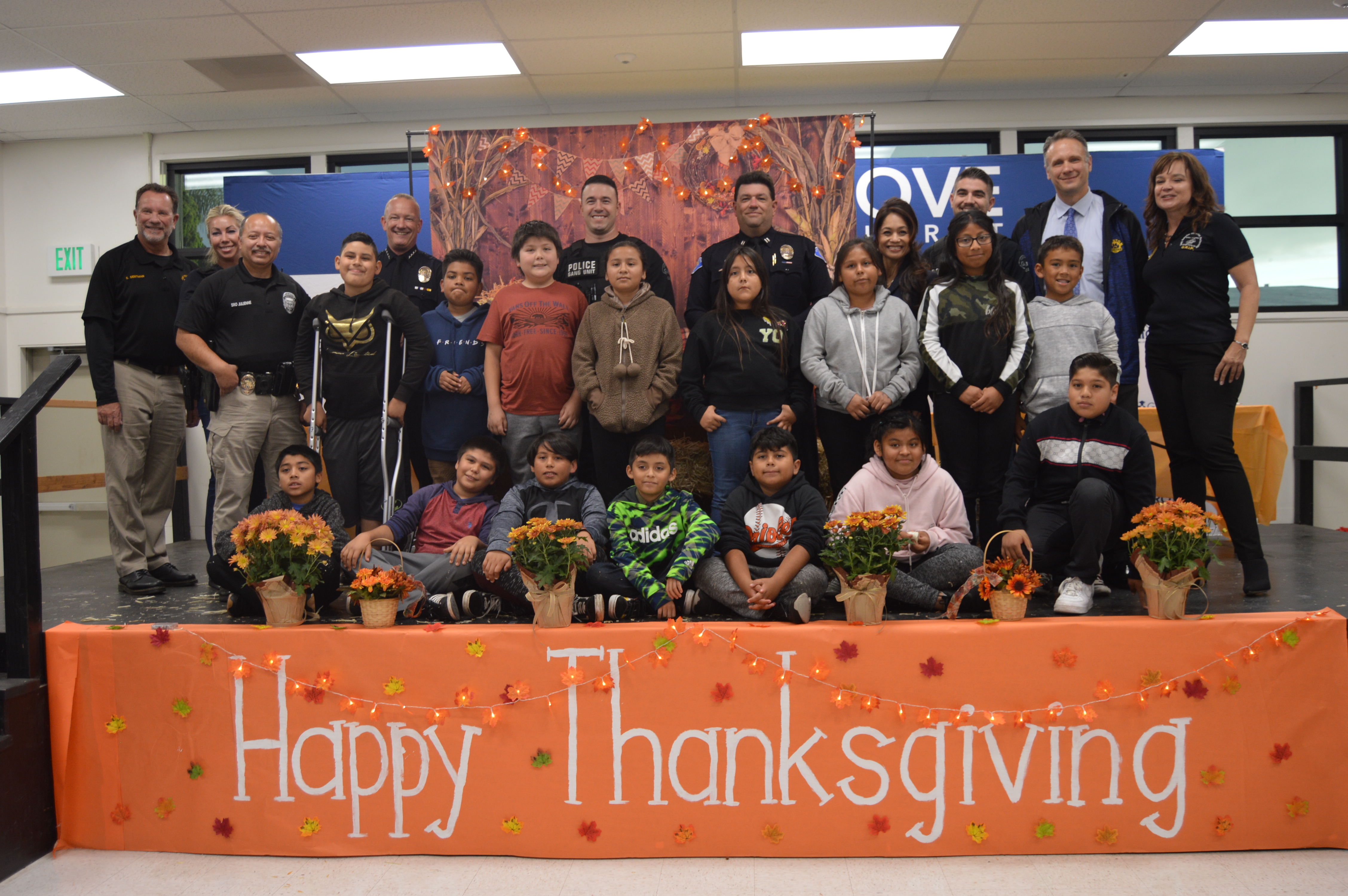 Students in front of a "Happy Thanksgiving" sign