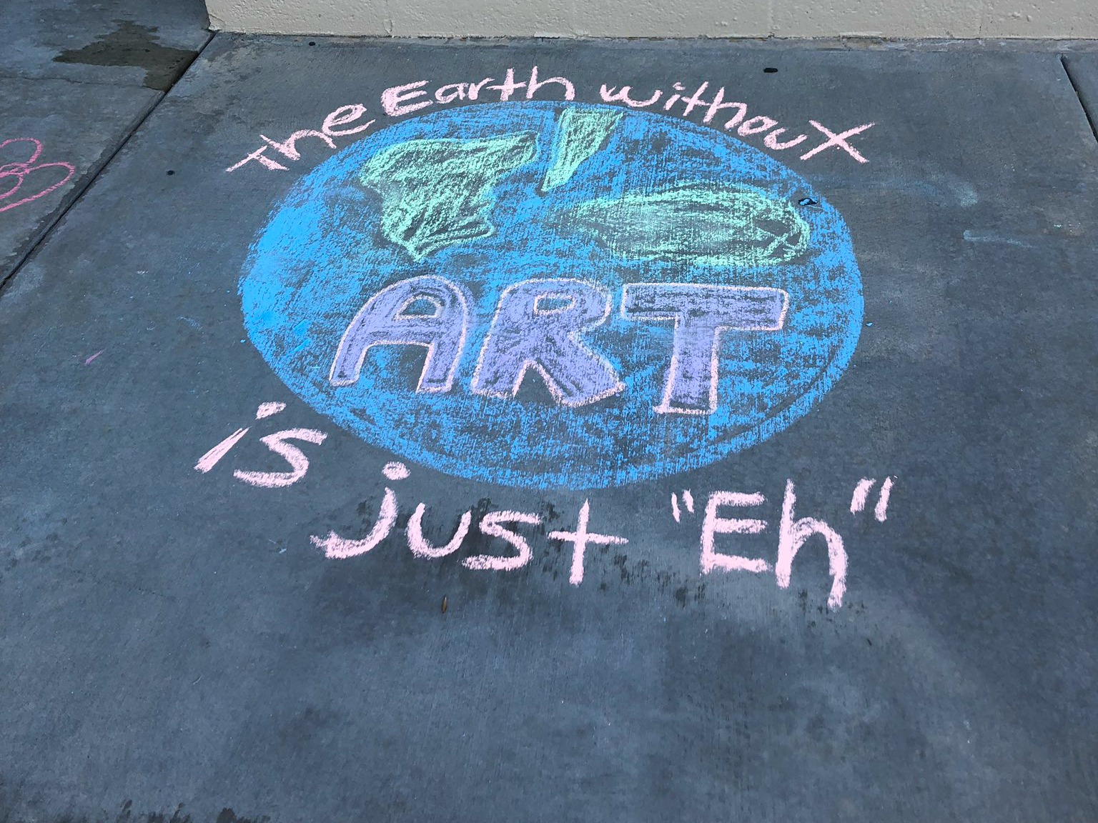 Chalk drawing that says, "The Earth without ART is just "eh."
