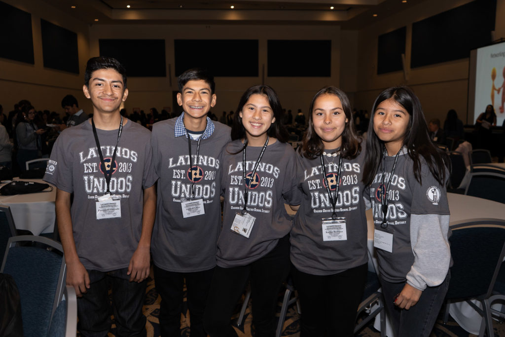 Five students in Latino Unidos T-shirts