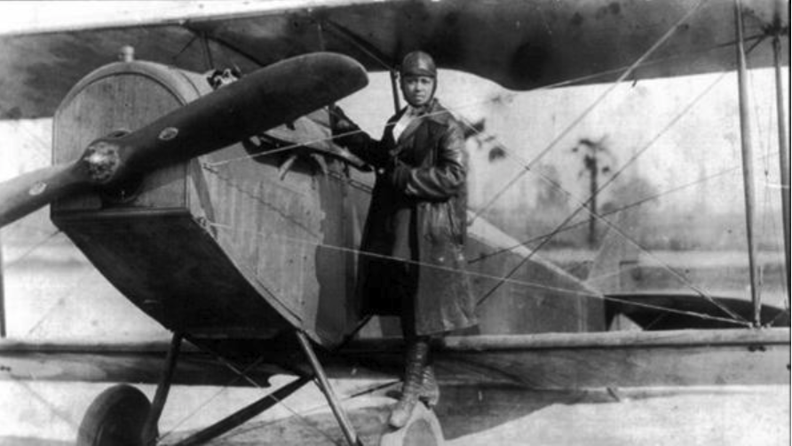 historic photo of female pilot on plane