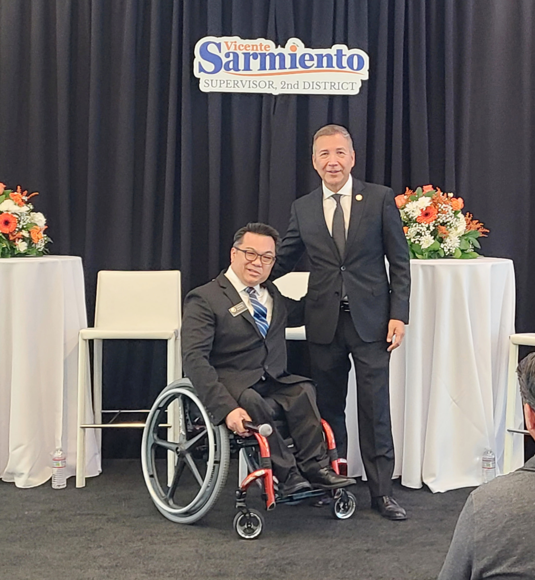 Dr. Stefan Bean poses with Supervisor Vicente Sarmiento on stage