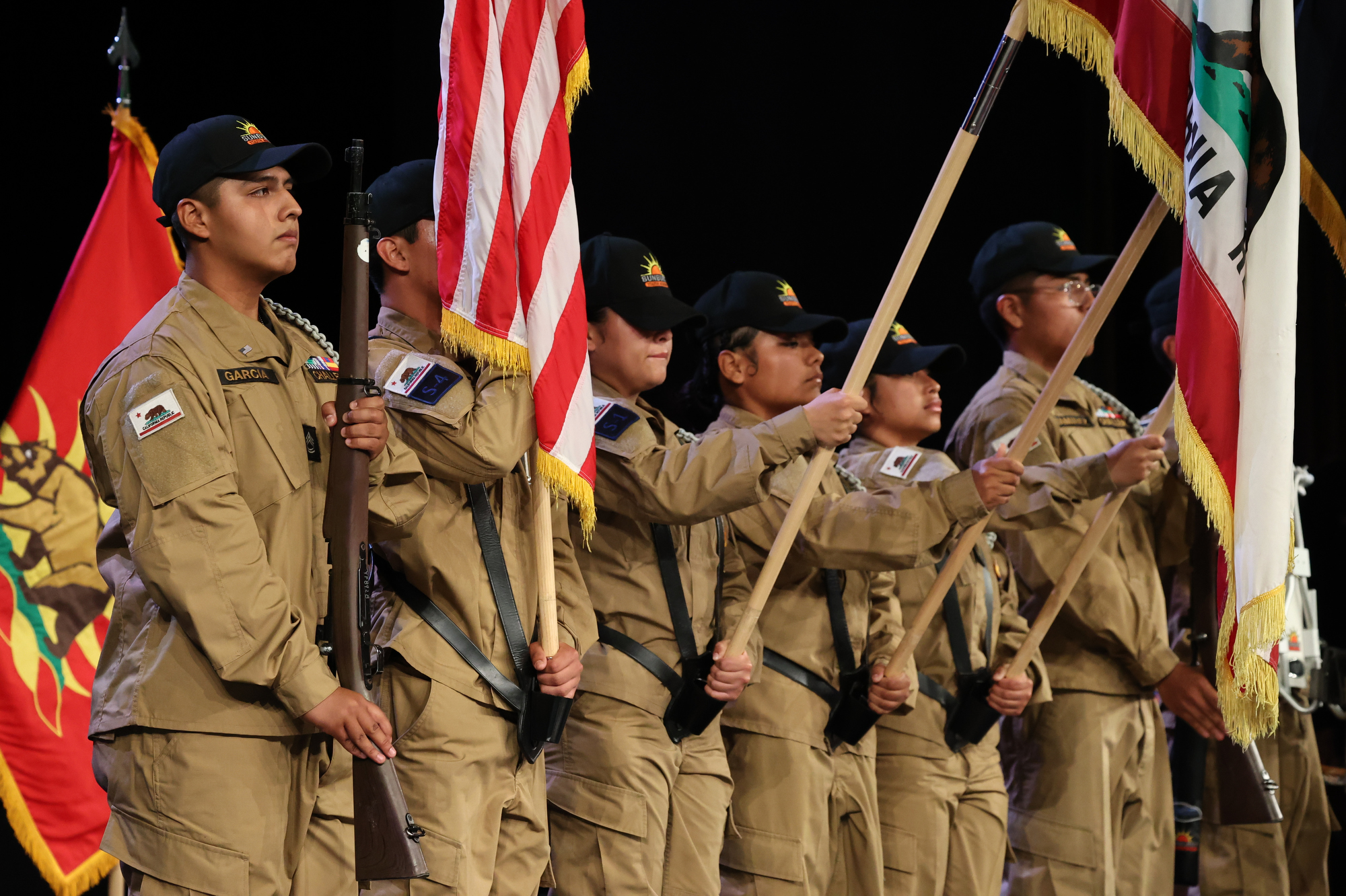 Sunburst Youth Academy cadets in uniform present the American and California flags as the color guard during the Class 35 commencement ceremony.