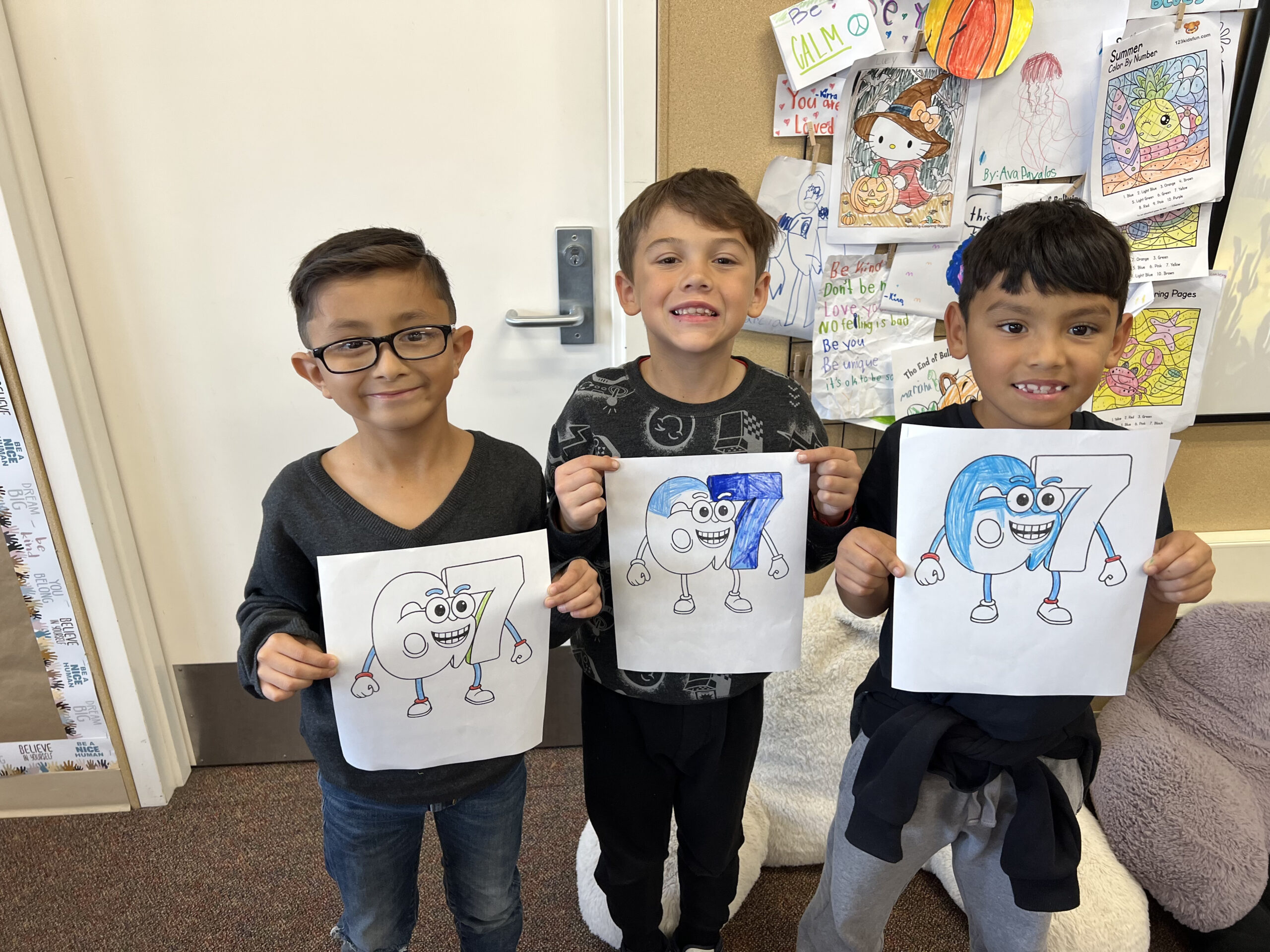 Students at Los Alamitos Elementary School show off their “six seven” coloring activities during a schoolwide celebration marking the 67th day of the school year.