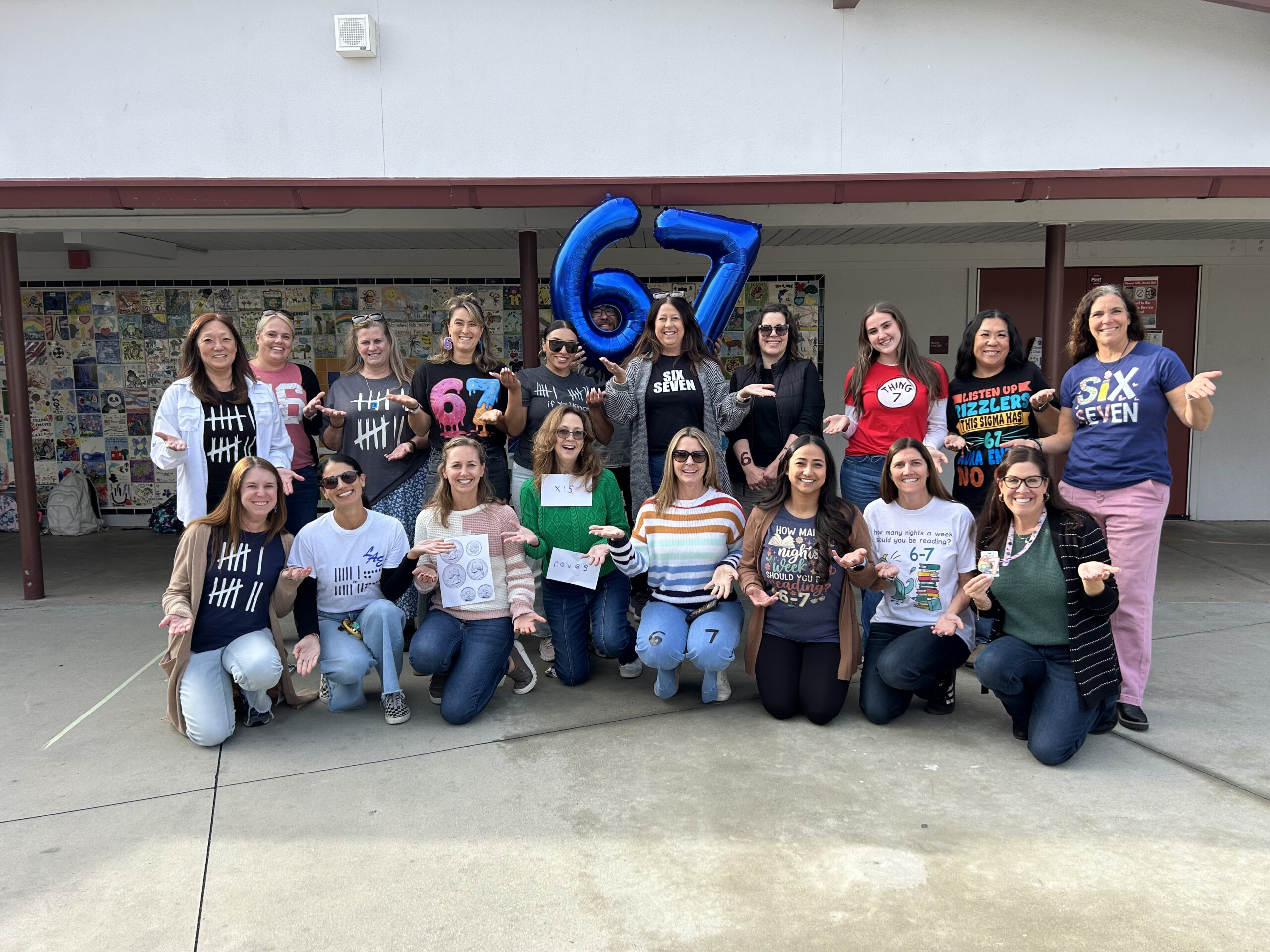 Teachers at Los Alamitos Elementary School sport their custom “six seven” shirts — many of them hand-designed — to celebrate the 67th day of the school year with students.
