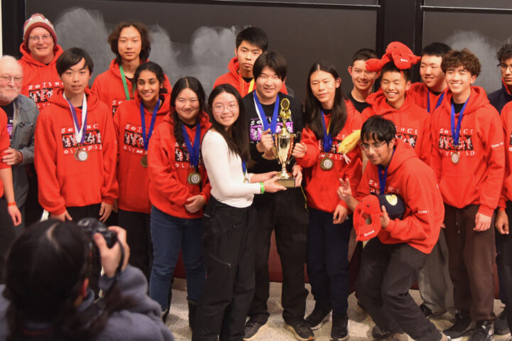 Members of the Troy High School Science Olympiad team pose with their first-place trophy at the 2026 MIT Science Olympiad Invitational.