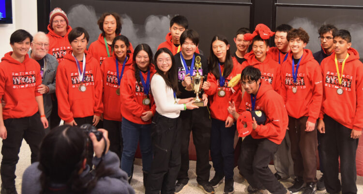 Members of the Troy High School Science Olympiad team pose with their first-place trophy at the 2026 MIT Science Olympiad Invitational.