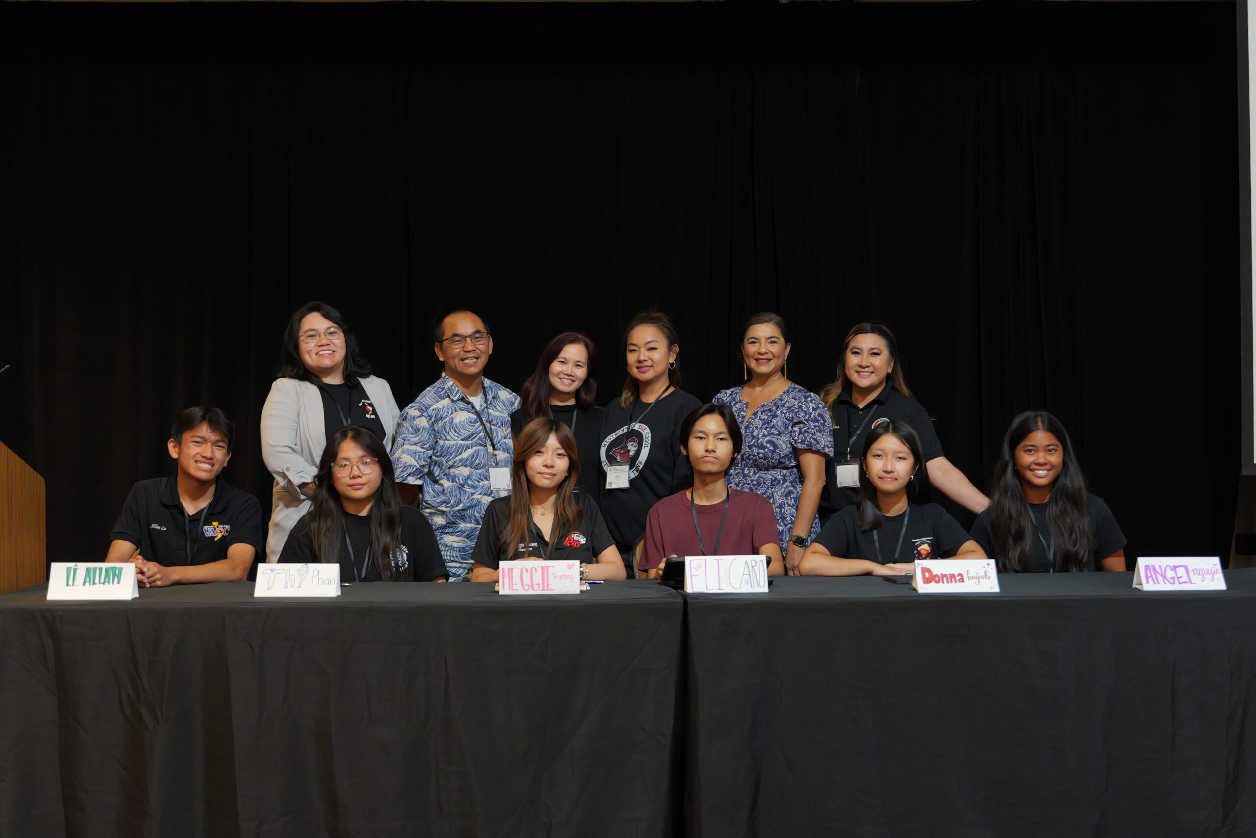 Westminster High School students share their perspectives on culture, leadership and identity during the closing session panel, “Building Community & Cultural Pride in Vietnamese American High Schoolers,” as their teachers stand behind them on stage.