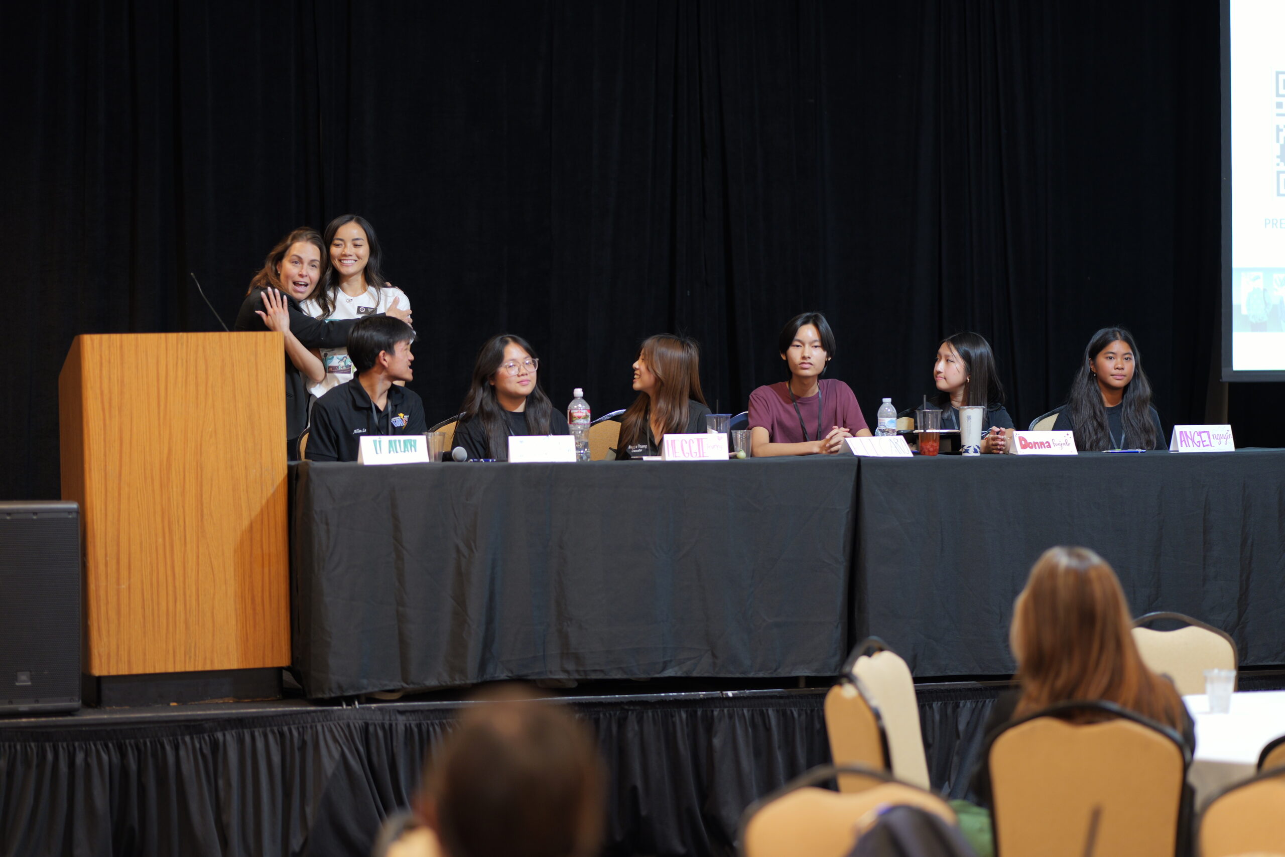 Dr. Marika Manos, OCDE’s history and social science manager, embraces program specialist Tori Phu as they thank Westminster High School teachers and students for their participation in the closing session.