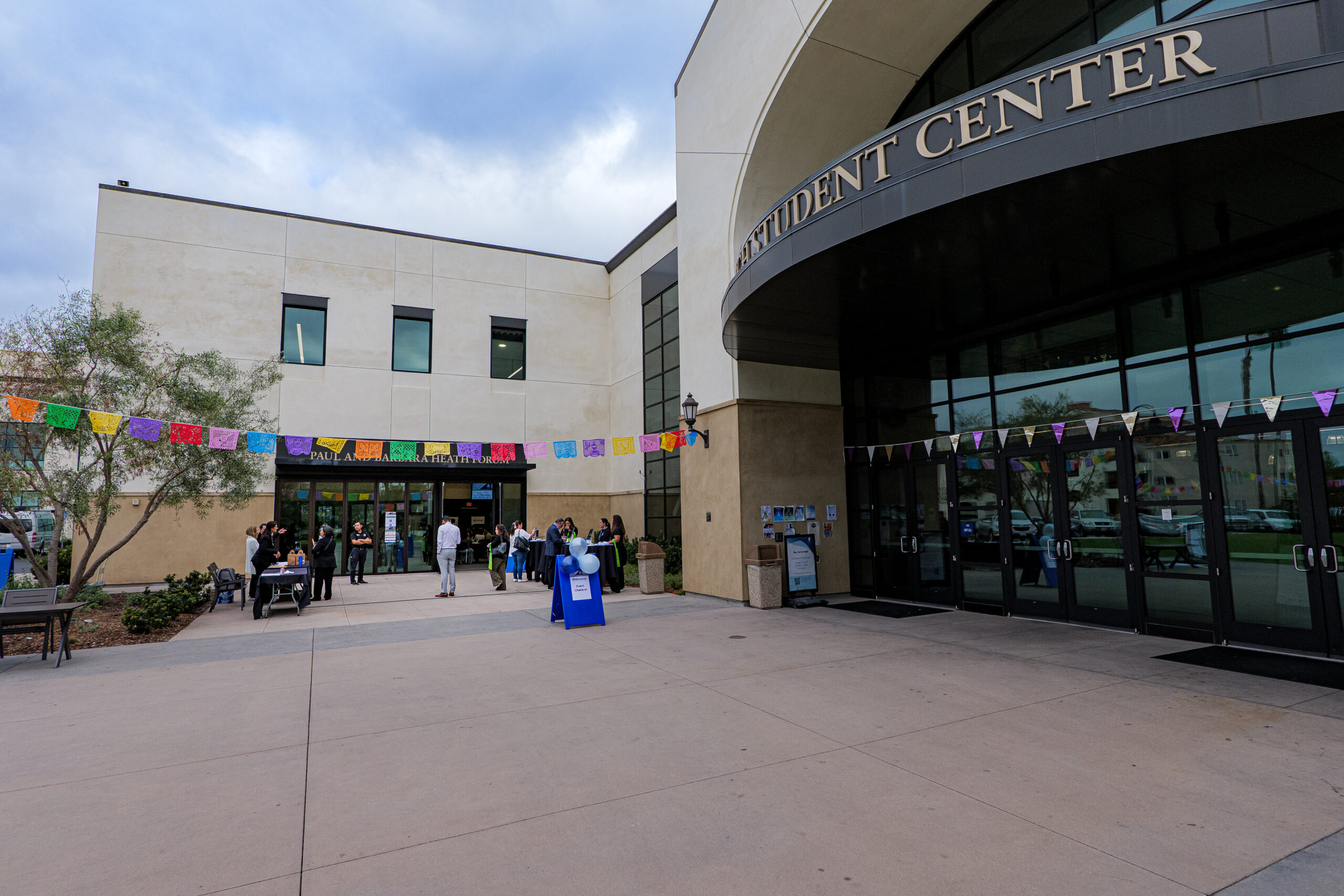 Staff from OCDE’s Events and Partnerships team assist attendees with registration outside the Paul and Barbara Heath Forum at Vanguard University in Costa Mesa, where the conference took place.