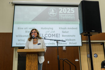 Natalia Abarca, coordinator of OCDE’s Language Services unit, welcomes guests to the 2025 Interpreters and Translators Conference.