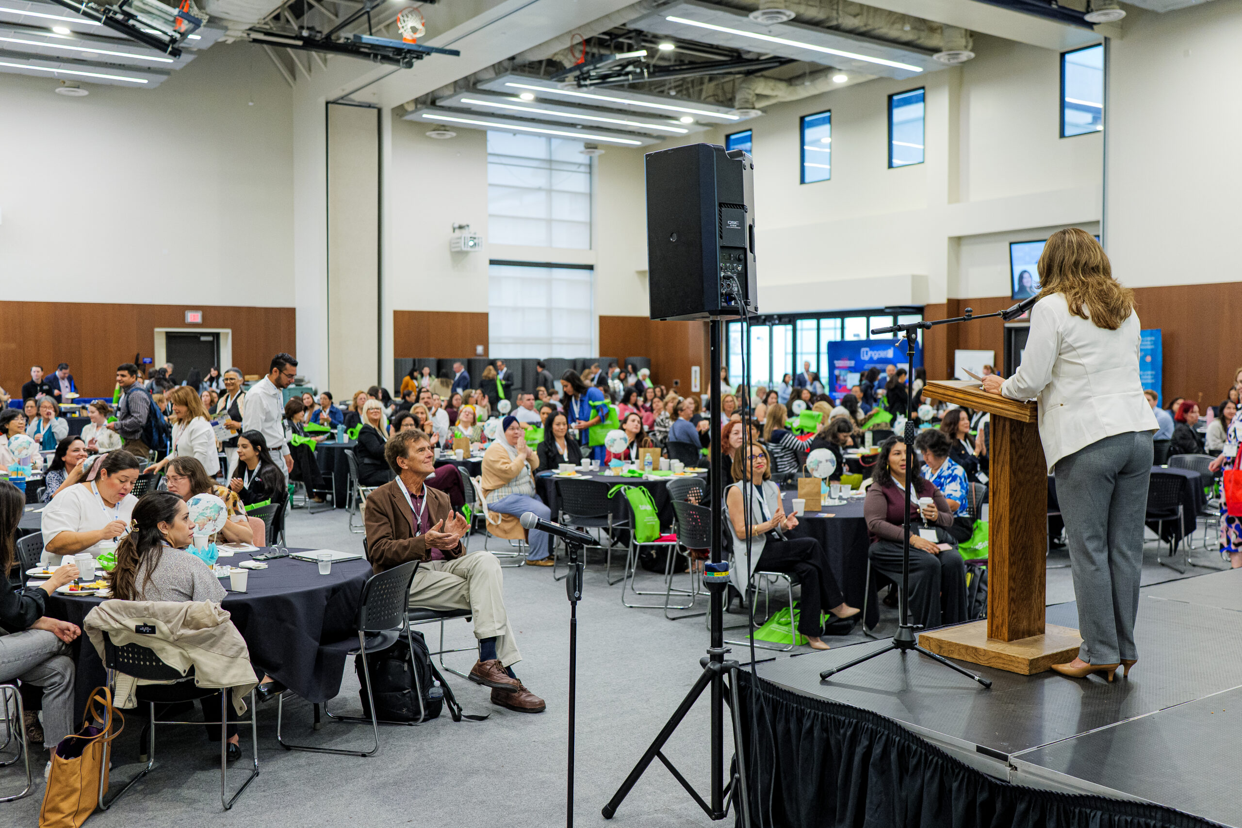 From the podium, Natalia Abarca addresses a full audience inside the Paul and Barbara Heath Forum during the 2025 Interpreters and Translators Conference.