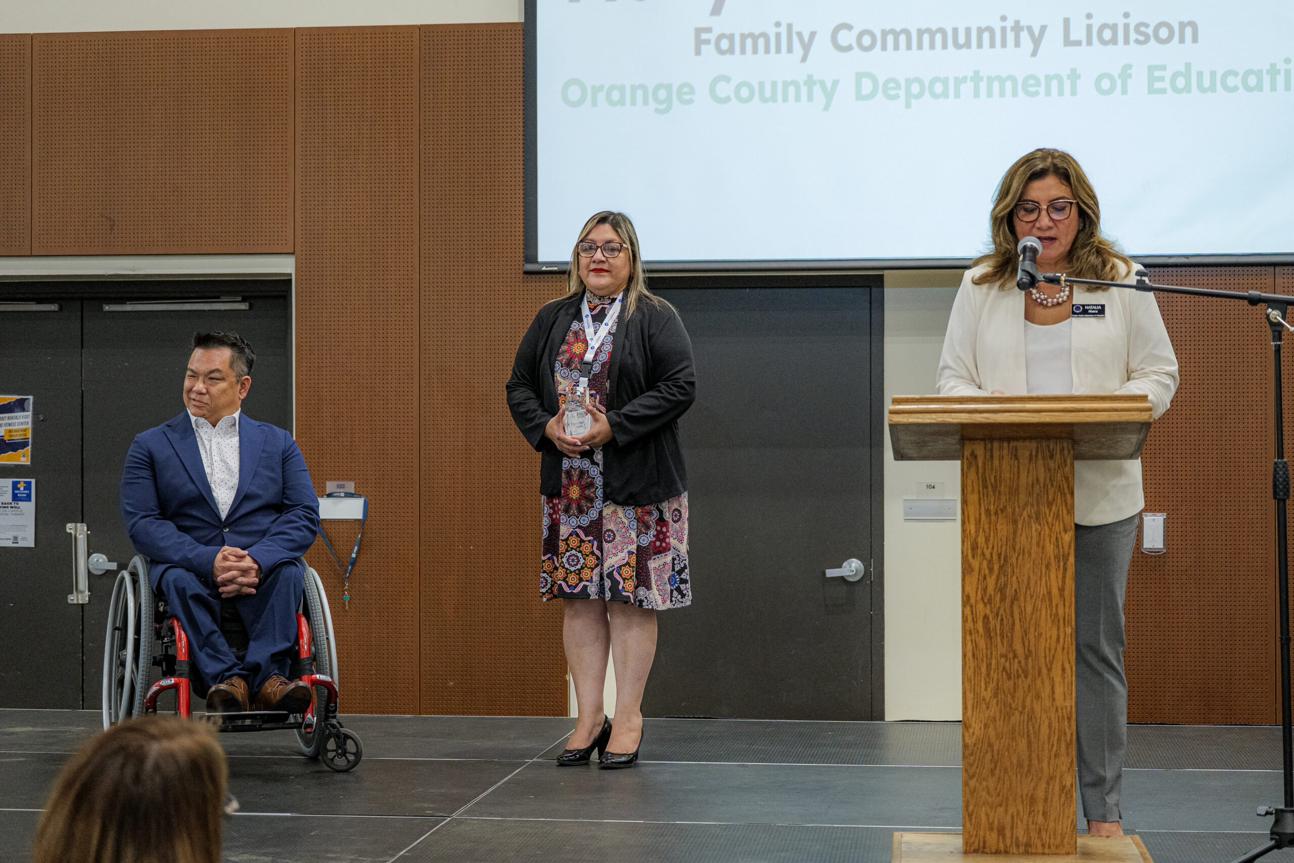 Natalia Abarca presents the Multilingual Award of Distinction to Marybelle Cano-Leon, a Family Community Liaison with OCDE’s ACCESS program.