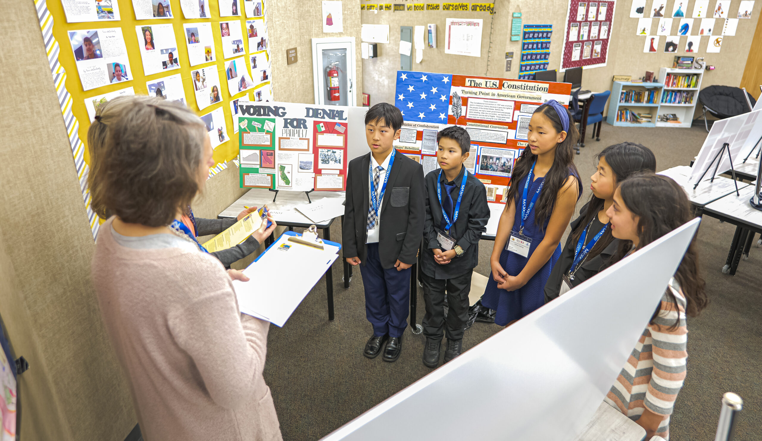 Students, wearing their medals, present their projects to judges for evaluation during the 2024 National History Day-Orange County competition.