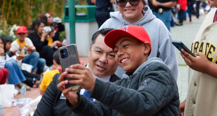 Dr. Bean takes a selfie with a student