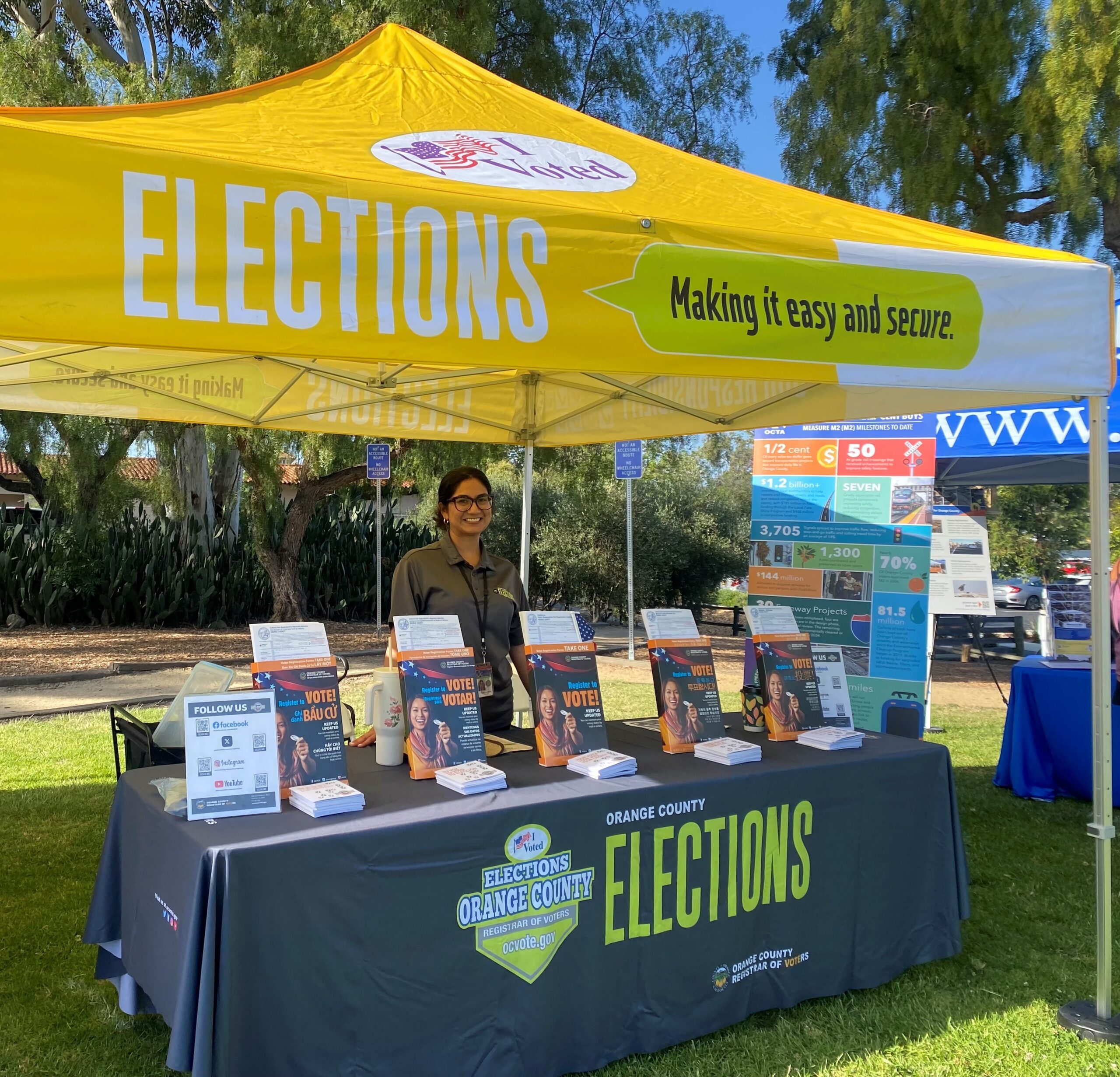 A representative from the Orange County Registrar of Voters shares voter registration information with attendees at the San Juan Summer Nights Concert series in San Juan Capistrano on June 18.