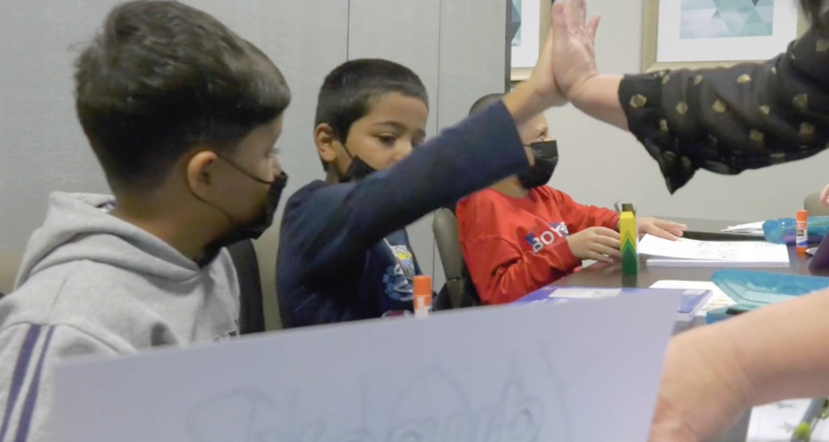 Student high-fiving teacher