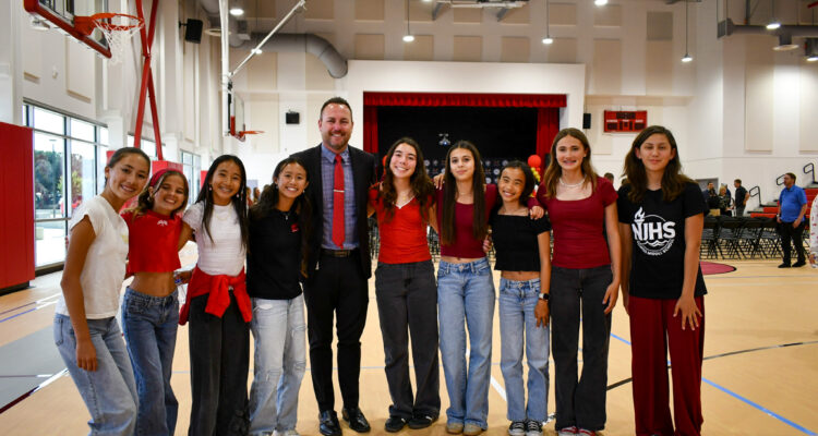 Sowers Middle School Principal Jeff Smith poses with students who volunteered to welcome guests during Wednesday’s ribbon-cutting event in Huntington Beach.
