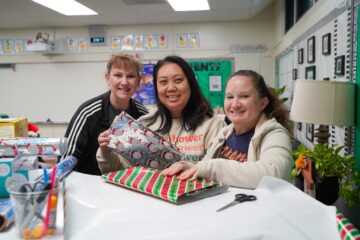 Teachers wrap gifts for their students