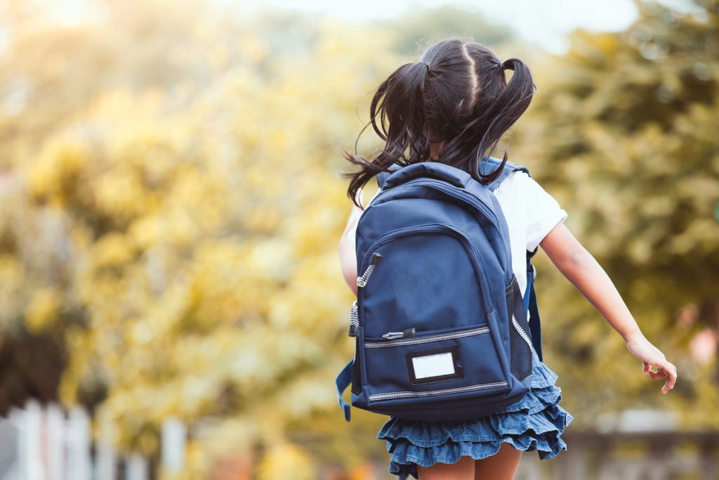 Student with backpack, running