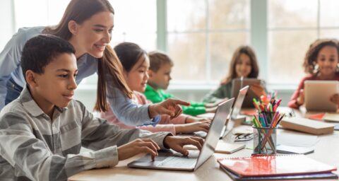 Teacher helping students